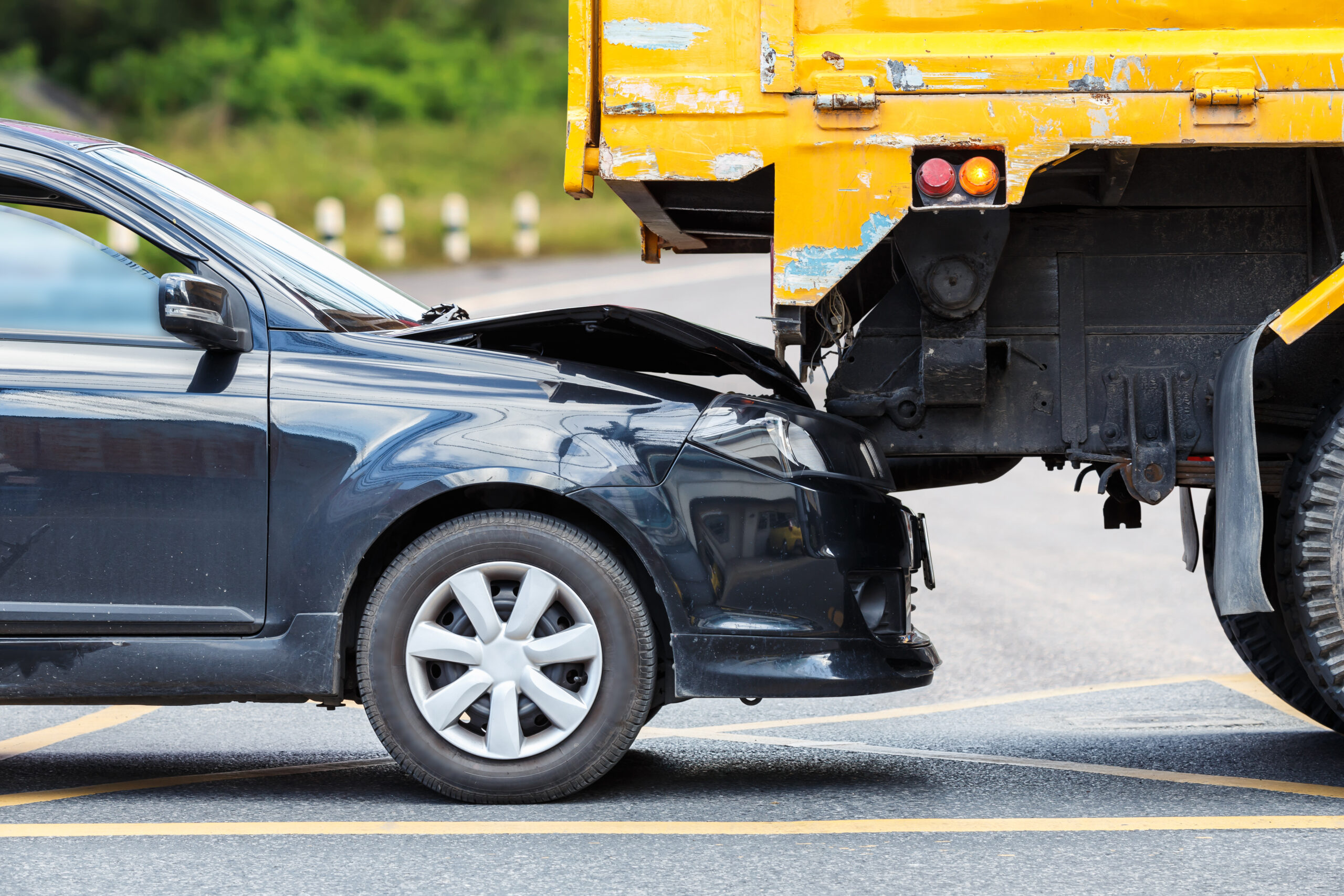 Accident on the road involving black car and yellow truck accident