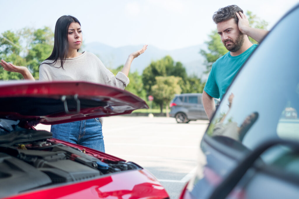 Angry stressed woman having a quarrel with one man after car crash. Police